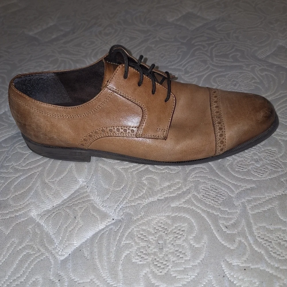A pair of Cole Haan Oxfords in a men's size 12M. Pre-loved in good condition.